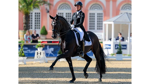 Ingrid Klimke horse riding at a dressage event